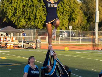 Cheerleader stunting at a football game