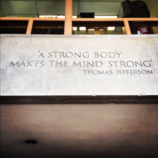 plaque on wall with text "a strong body makes the mind strong